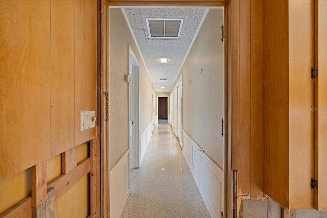 hall with light speckled floor and visible vents