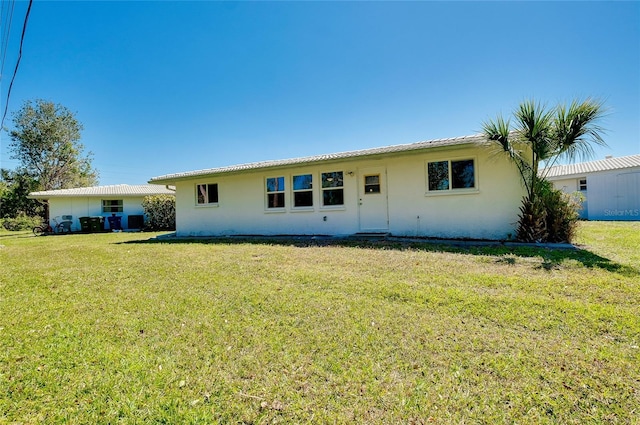 rear view of property featuring a yard