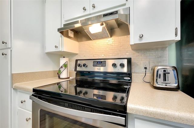 kitchen featuring white cabinetry, light countertops, electric stove, and under cabinet range hood