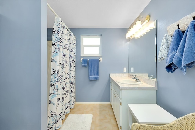 full bath featuring tile patterned floors, vanity, a shower with shower curtain, and baseboards