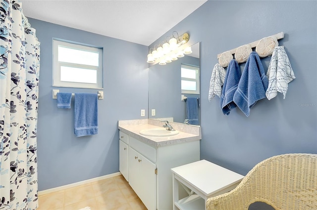 bathroom featuring vanity, a shower with curtain, baseboards, and tile patterned flooring