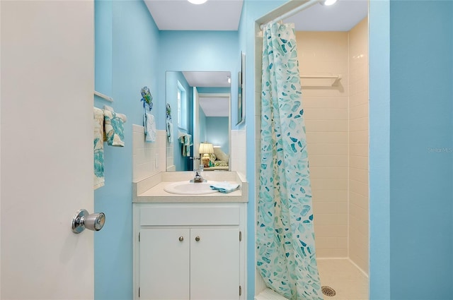 full bath with a stall shower and vanity