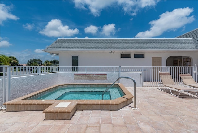 view of swimming pool with a patio area and a community hot tub