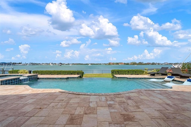 view of swimming pool with a pool with connected hot tub and a patio area