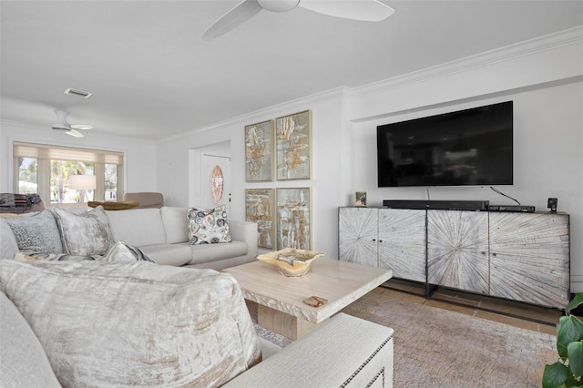 living area featuring ceiling fan, visible vents, crown molding, and wood finished floors