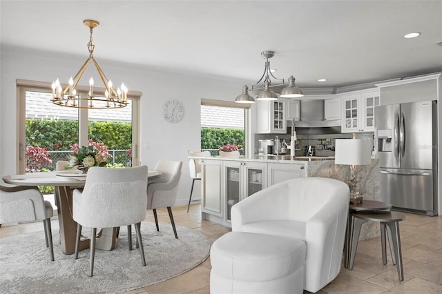 dining area with ornamental molding, recessed lighting, and an inviting chandelier