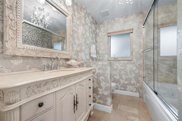 bathroom with baseboards, toilet, and wallpapered walls