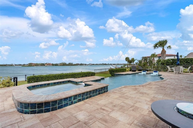 pool featuring a water view, a patio, fence, and an in ground hot tub