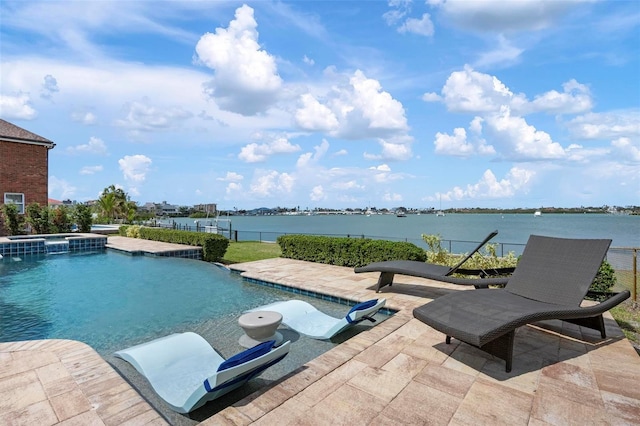 view of pool featuring a water view, a patio area, and a pool with connected hot tub