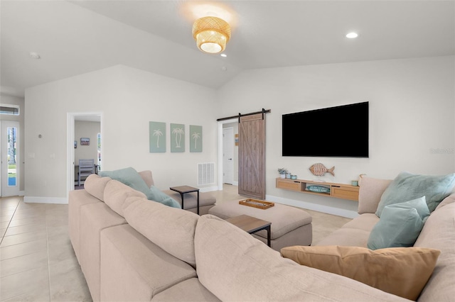 living room with light tile patterned floors, a barn door, visible vents, baseboards, and lofted ceiling