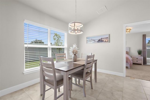 dining space with light tile patterned floors, a chandelier, visible vents, and baseboards