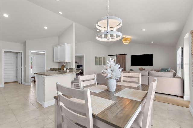 dining area featuring lofted ceiling, light tile patterned floors, a notable chandelier, and recessed lighting