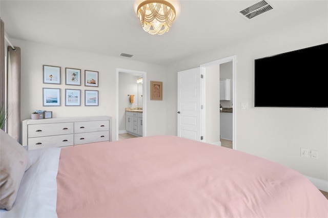 bedroom featuring connected bathroom and visible vents