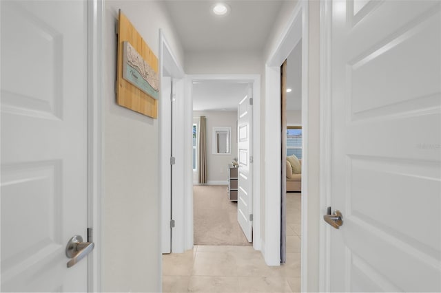 hallway featuring light tile patterned floors, light carpet, and recessed lighting