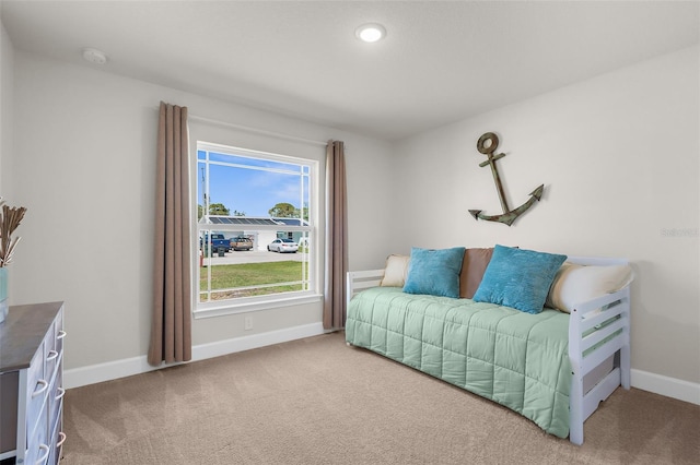 sitting room featuring carpet and baseboards