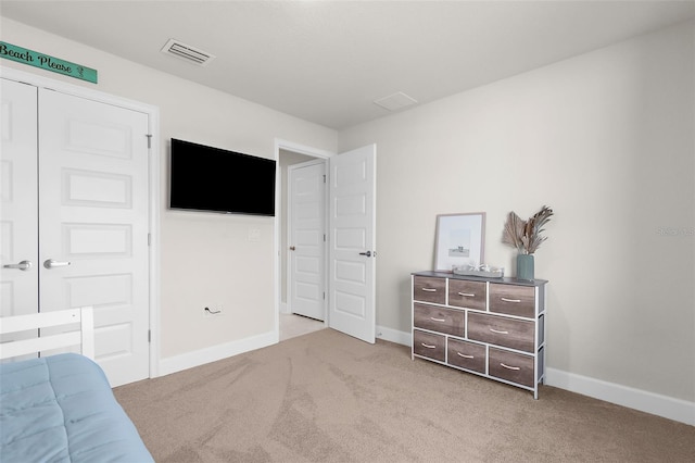 carpeted bedroom featuring baseboards and visible vents