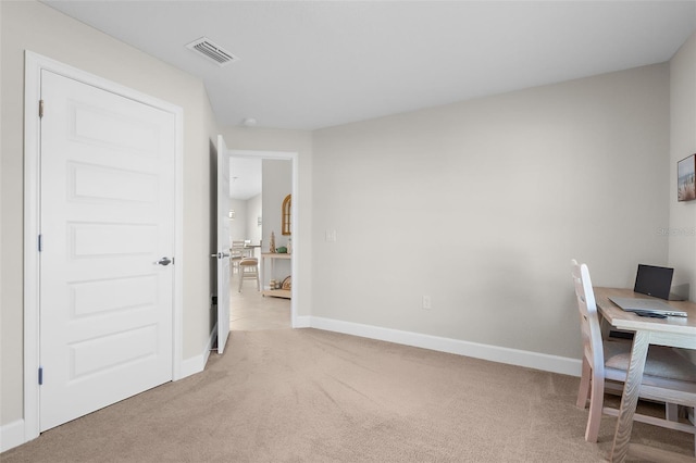 office area with light carpet, visible vents, and baseboards