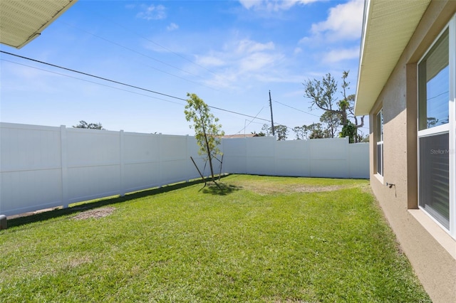 view of yard with a fenced backyard