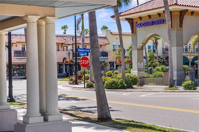 view of street featuring sidewalks, traffic signs, and curbs