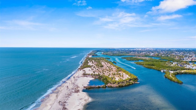 birds eye view of property featuring a water view and a beach view