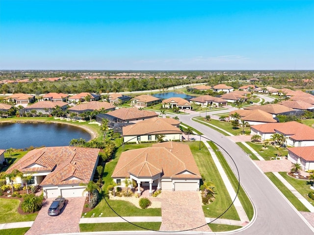 drone / aerial view featuring a water view and a residential view