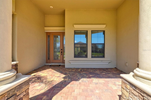 property entrance with stucco siding