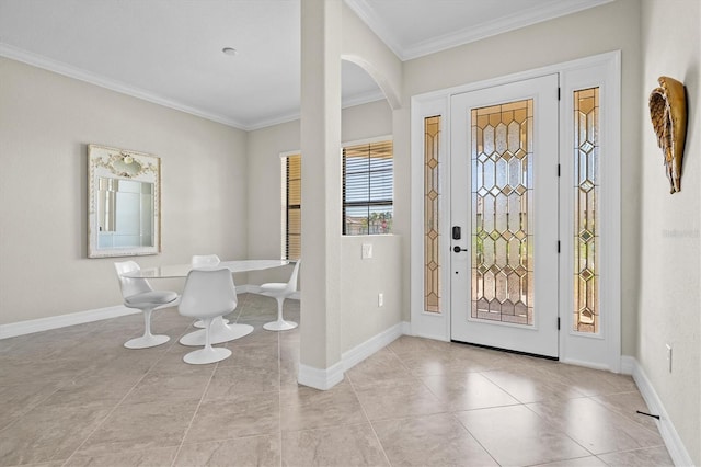 foyer entrance with ornamental molding, baseboards, and light tile patterned floors