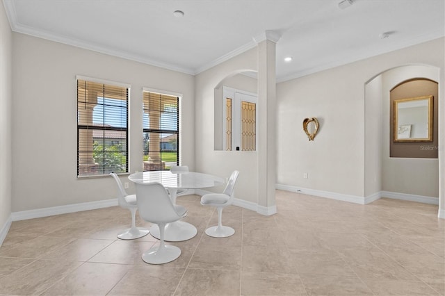 dining space featuring ornamental molding, arched walkways, light tile patterned flooring, and baseboards