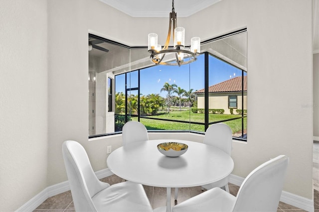 dining space featuring tile patterned flooring, crown molding, baseboards, and an inviting chandelier