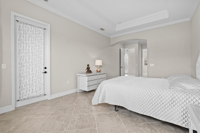 bedroom featuring arched walkways, light tile patterned flooring, visible vents, a raised ceiling, and crown molding