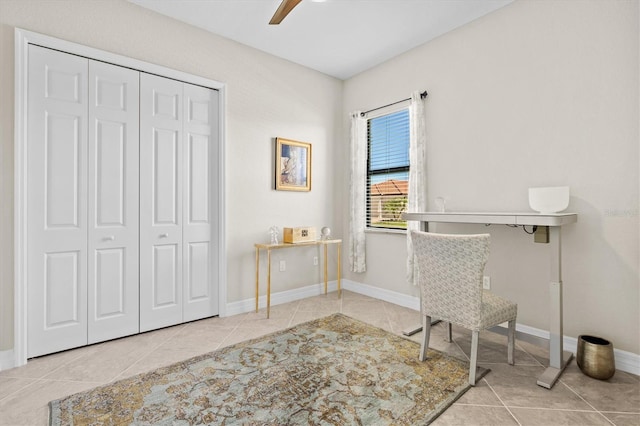 office space with ceiling fan, tile patterned flooring, and baseboards