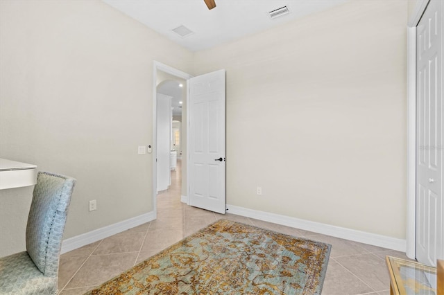 tiled bedroom with a ceiling fan, a closet, visible vents, and baseboards