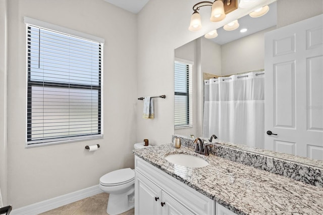 bathroom featuring toilet, vanity, a shower with curtain, baseboards, and tile patterned floors