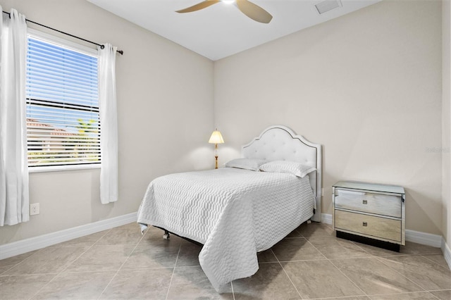 tiled bedroom with ceiling fan, visible vents, and baseboards