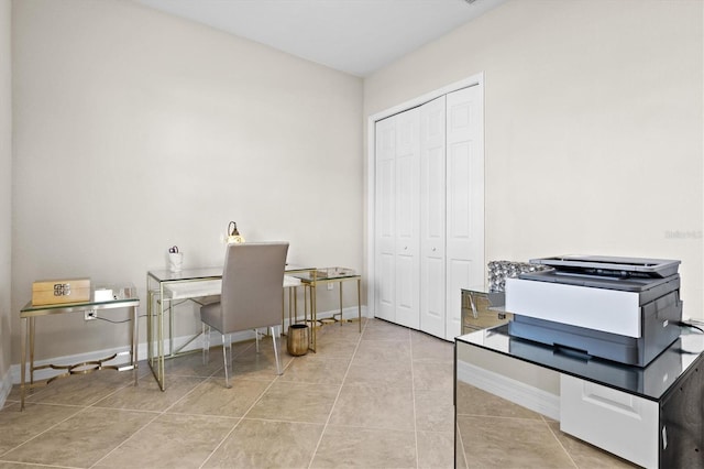 office space featuring baseboards and tile patterned floors