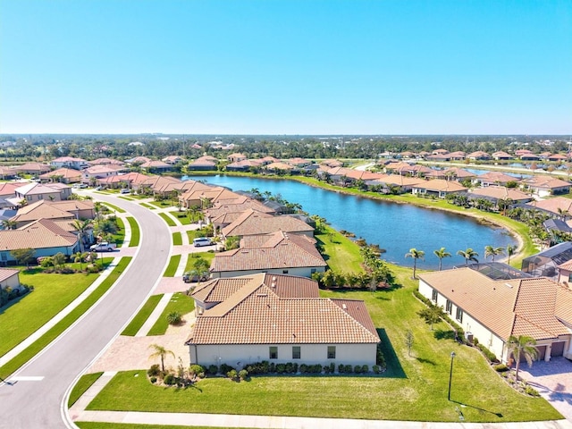 birds eye view of property with a water view and a residential view