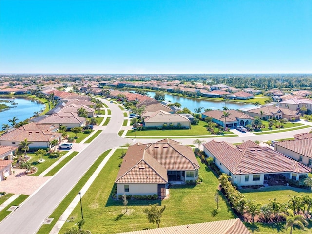 drone / aerial view featuring a residential view and a water view