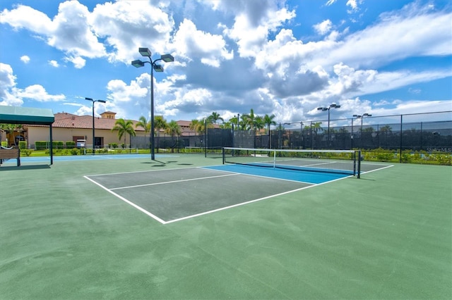 view of tennis court with fence