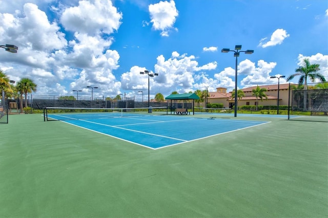 view of tennis court featuring fence