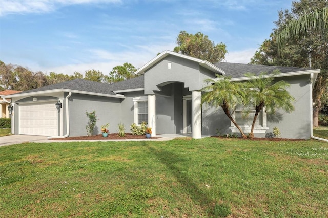 single story home with stucco siding, a front yard, an attached garage, and driveway