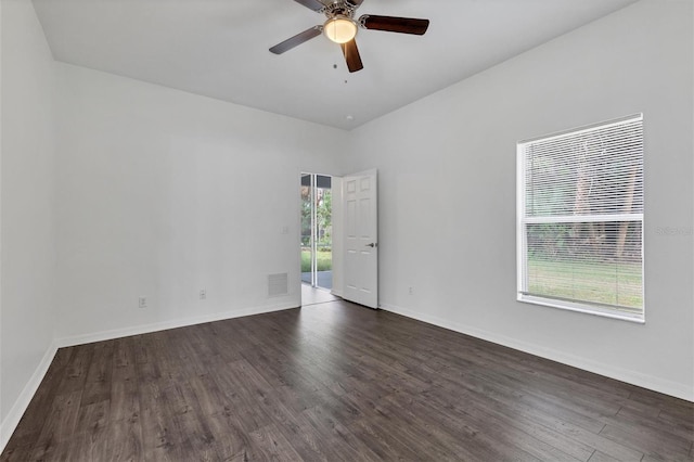 unfurnished room featuring visible vents, baseboards, dark wood-type flooring, and ceiling fan