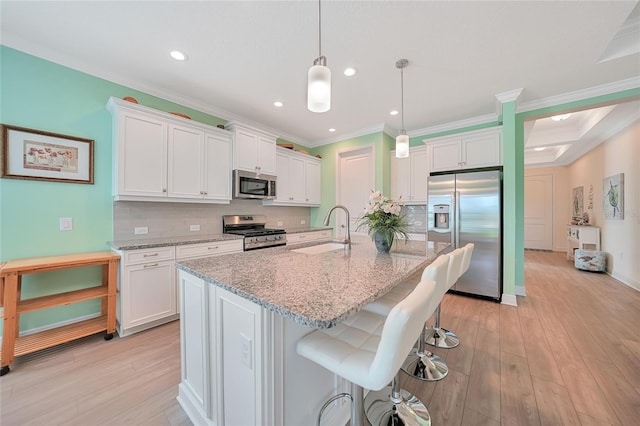 kitchen featuring white cabinetry, appliances with stainless steel finishes, and a sink