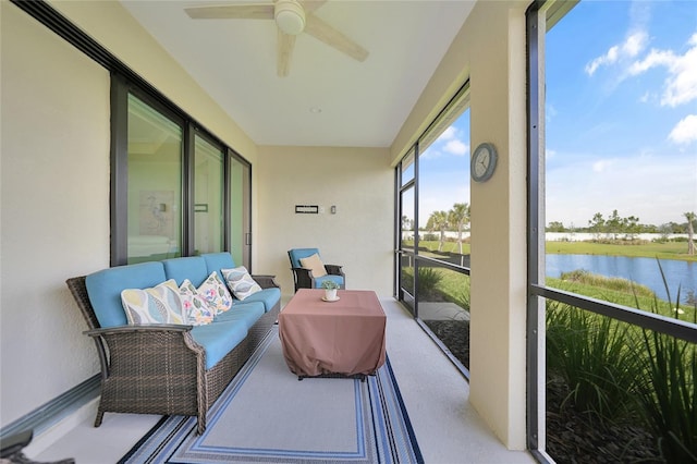 sunroom / solarium featuring a water view and ceiling fan