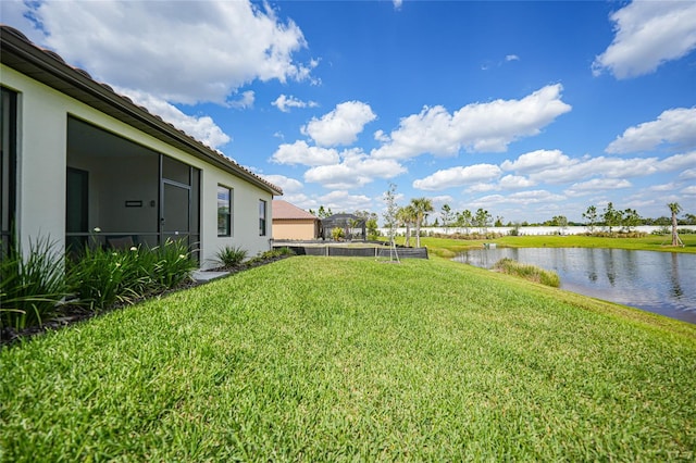 view of yard featuring a water view and a vegetable garden