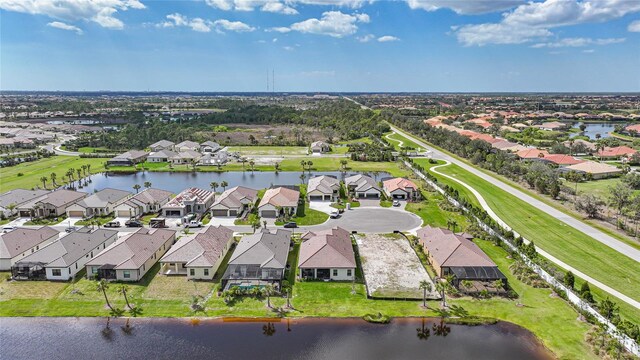 drone / aerial view with a water view and a residential view