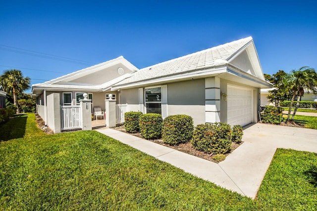 view of front facade featuring a garage, concrete driveway, a front yard, and stucco siding