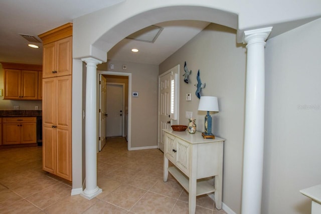 corridor featuring visible vents, recessed lighting, arched walkways, light tile patterned flooring, and ornate columns