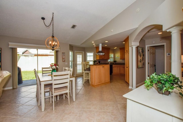 dining room featuring ornate columns, visible vents, lofted ceiling, and light tile patterned floors