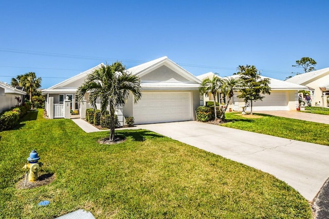 ranch-style home with stucco siding, a front lawn, a garage, and driveway