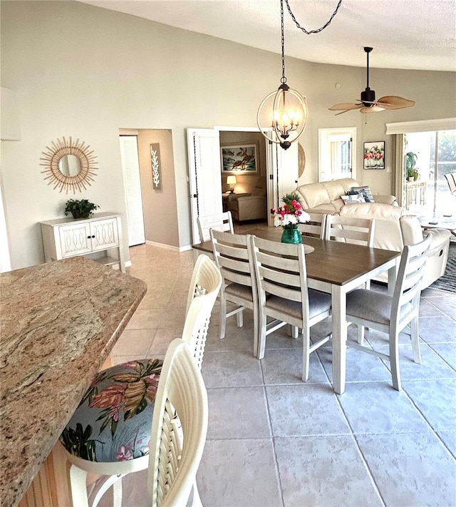 dining area with light tile patterned floors, high vaulted ceiling, a textured ceiling, and a ceiling fan